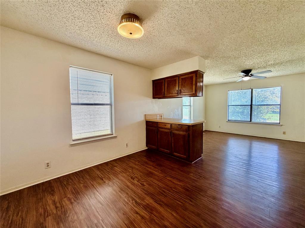 3311 Fallmeadow Street Denton, TX 76207 - Photo 7 of 13 an empty room with windows and cabinet