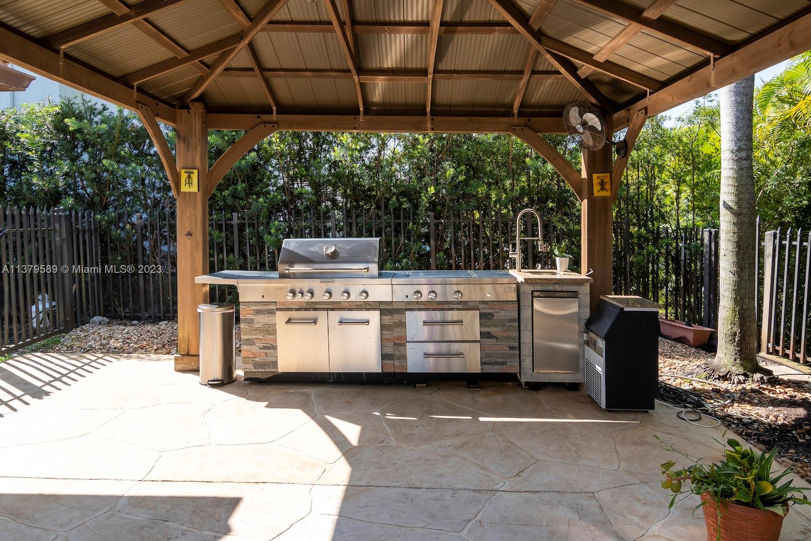 Doral Doral, FL 33178 - Photo 13 of 52 a view of a patio with table and chairs under an umbrella