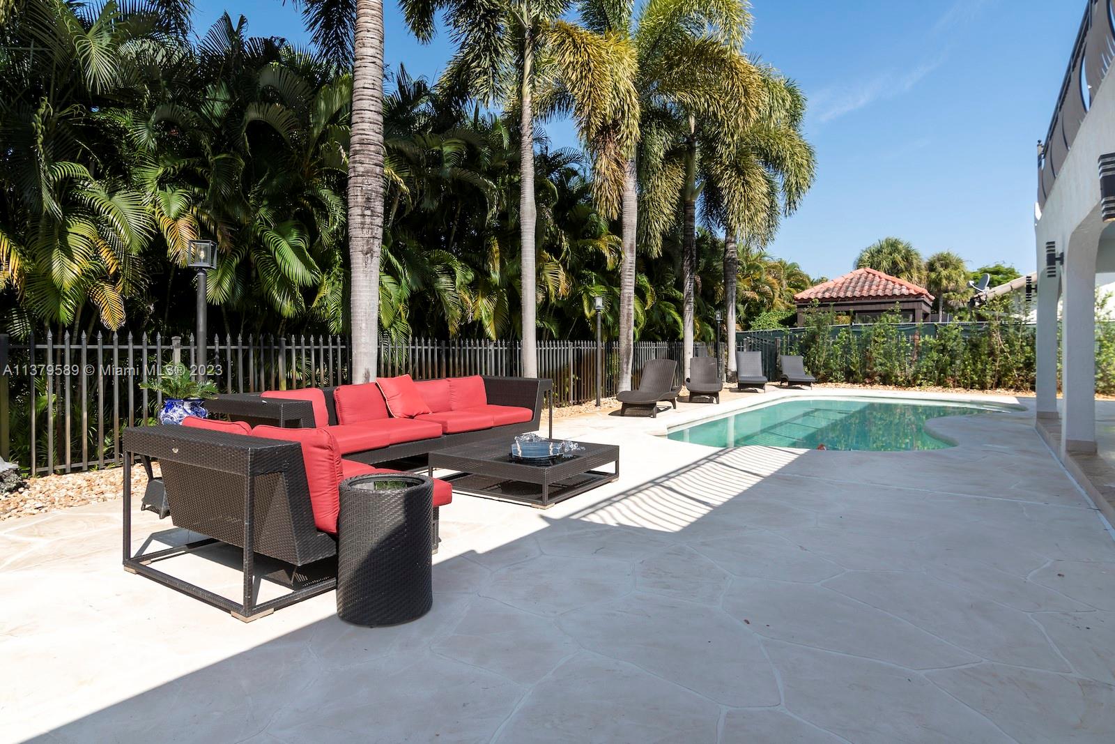 Doral Doral, FL 33178 - Photo 15 of 52 a backyard of a house with barbeque oven table and chairs