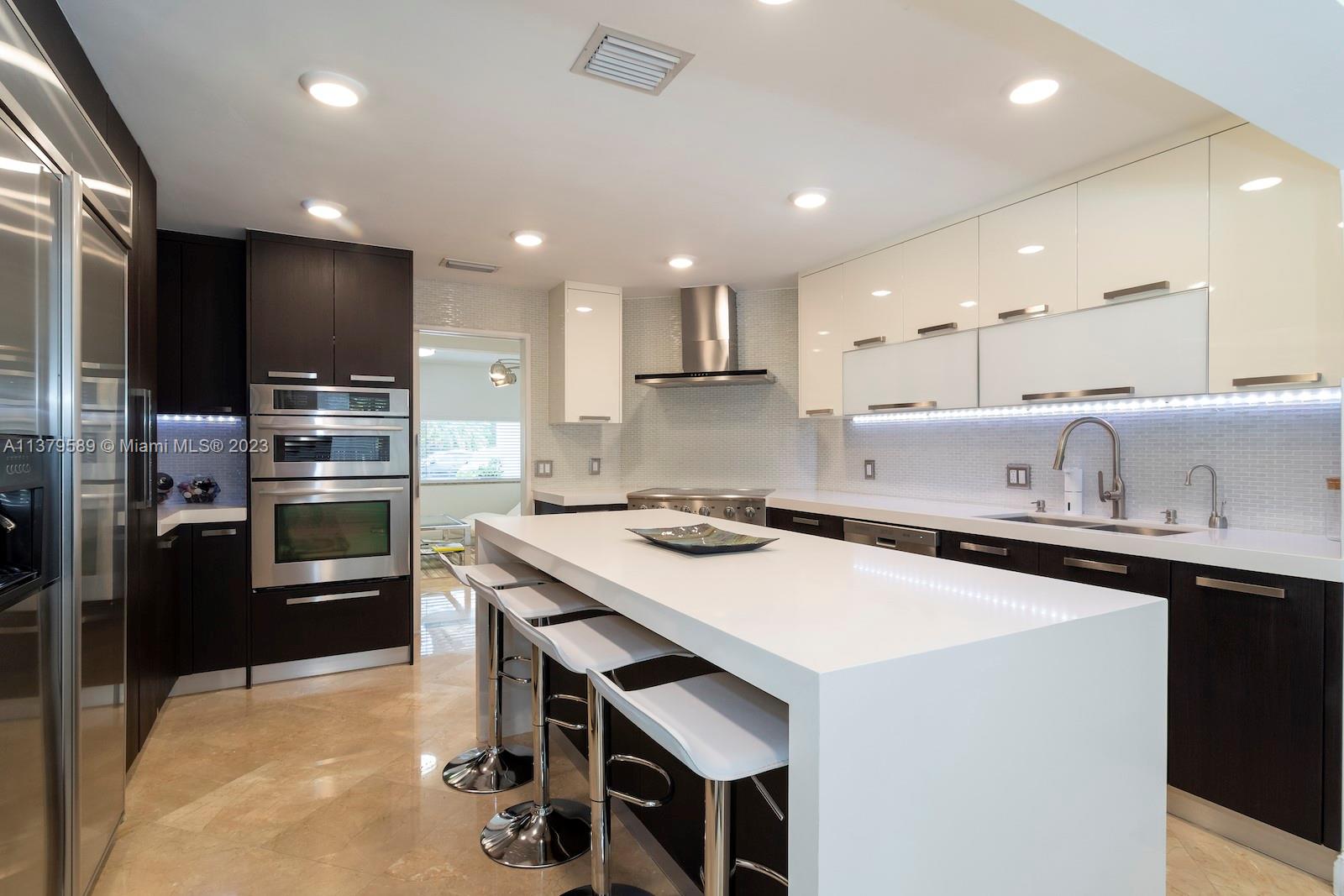 Doral Doral, FL 33178 - Photo 26 of 52 a kitchen that has a sink a stove and chairs