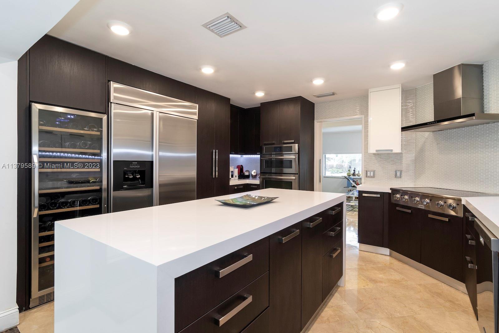 Doral Doral, FL 33178 - Photo 27 of 52 a kitchen with kitchen island a sink stainless steel appliances and cabinets