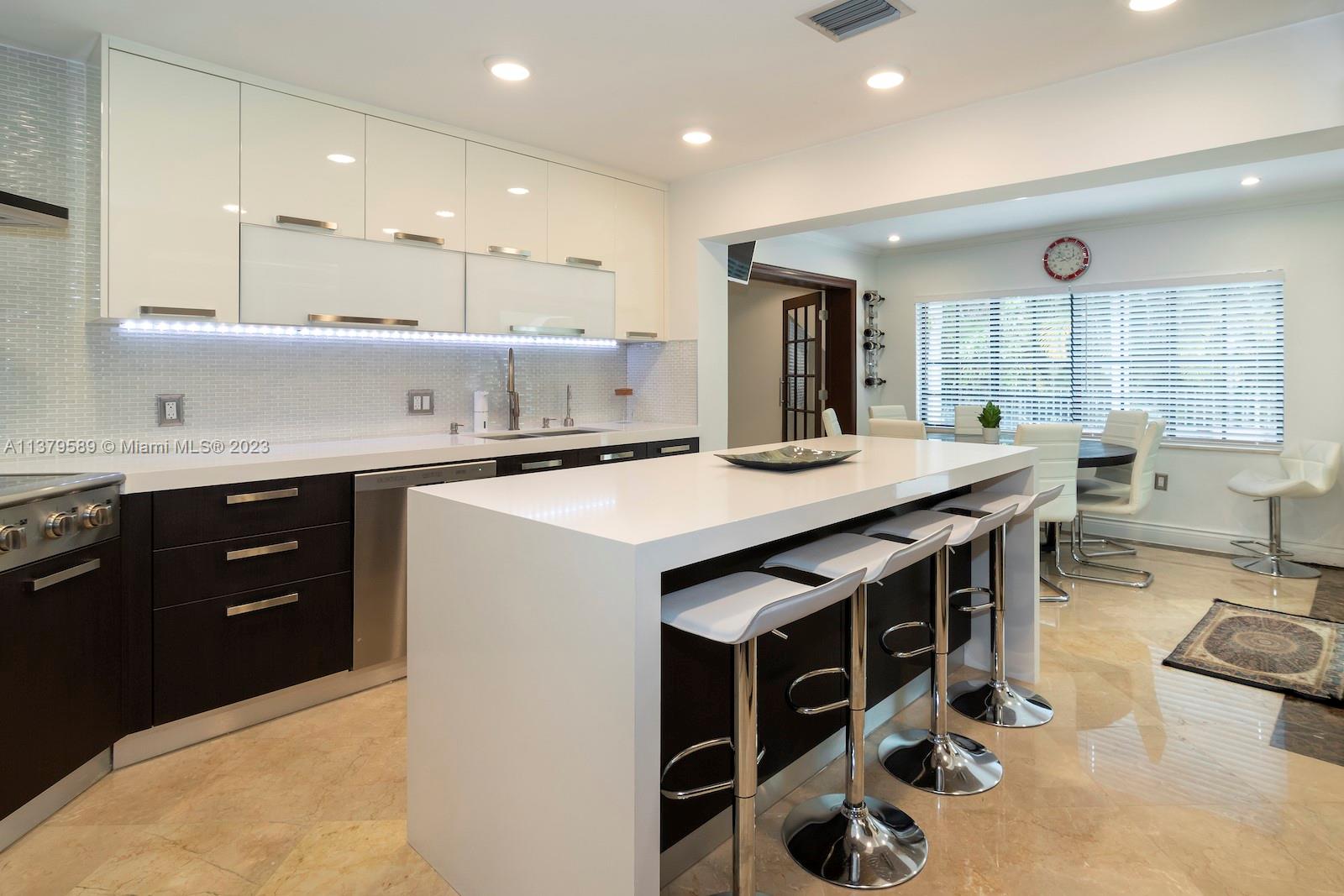 Doral Doral, FL 33178 - Photo 29 of 52 a kitchen with stainless steel appliances kitchen island granite countertop a sink and a stove