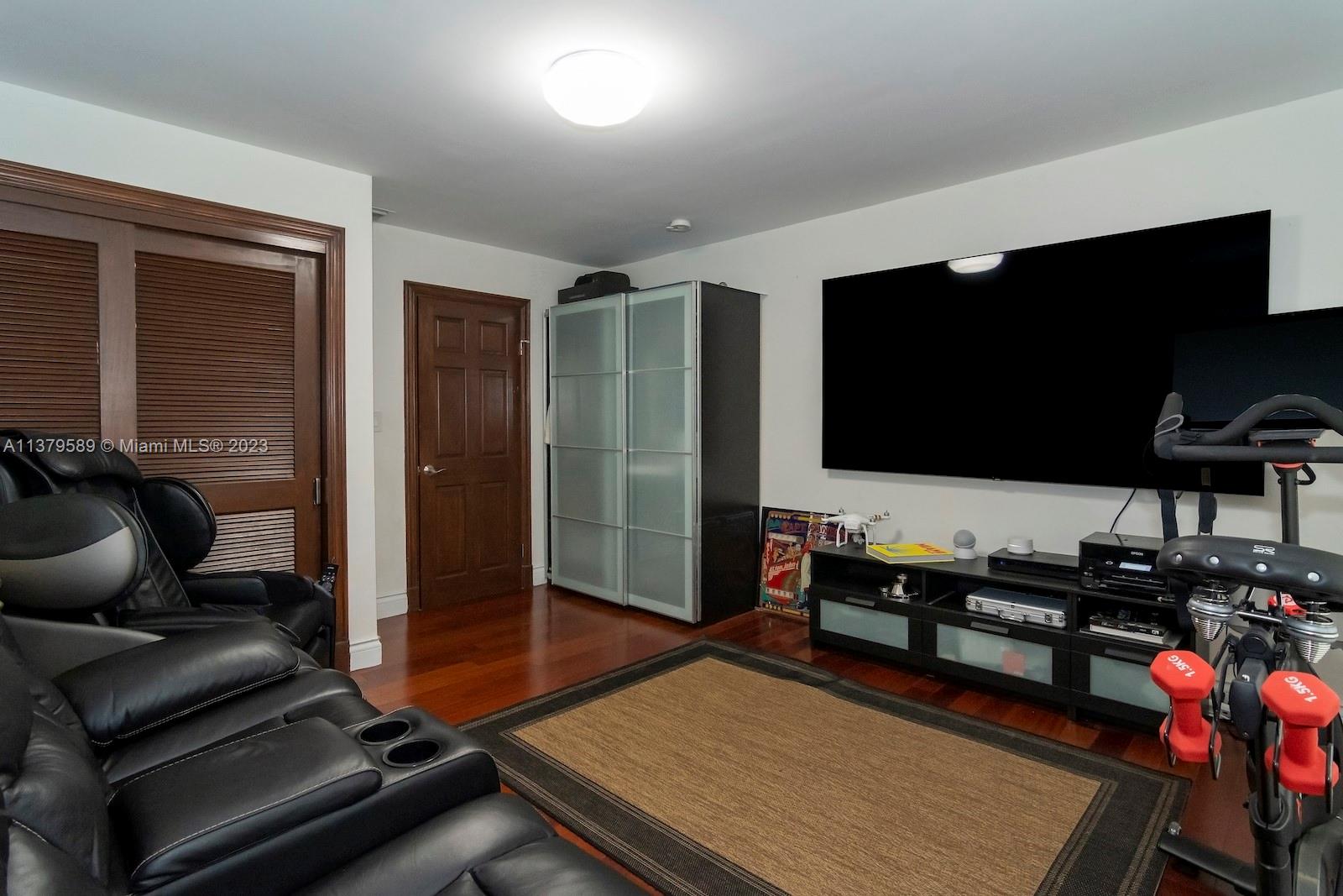 Doral Doral, FL 33178 - Photo 33 of 52 a living room with furniture and a flat screen tv