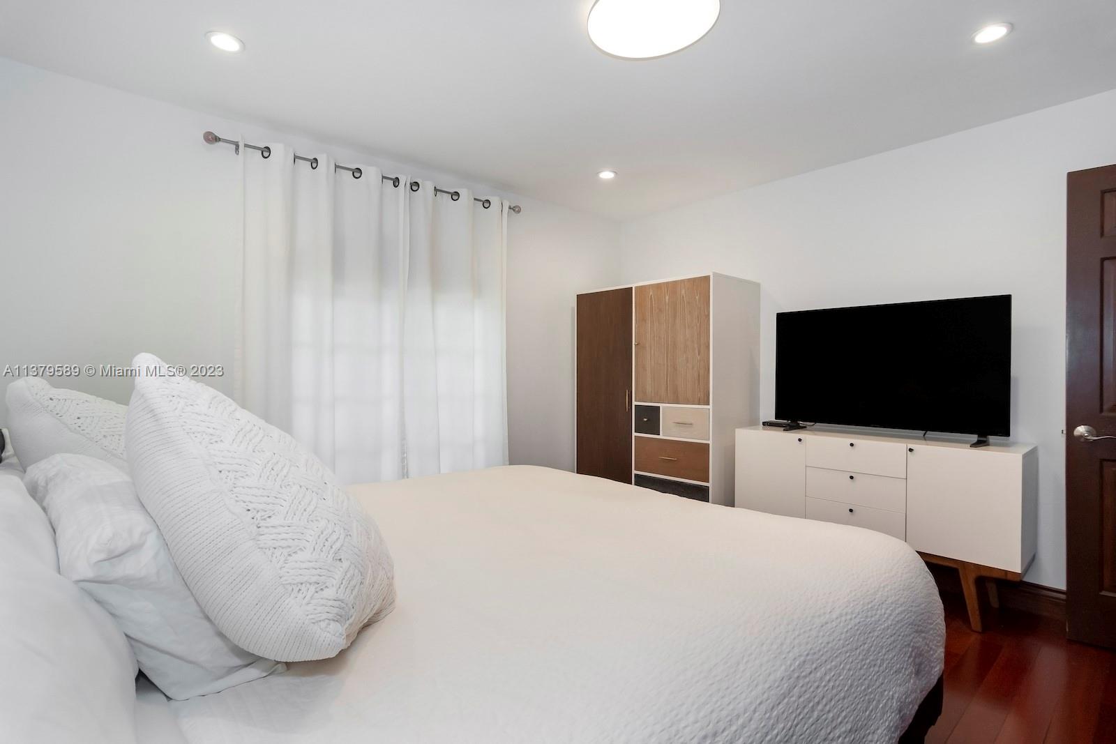 Doral Doral, FL 33178 - Photo 36 of 52 a bedroom with a bed and a flat screen tv