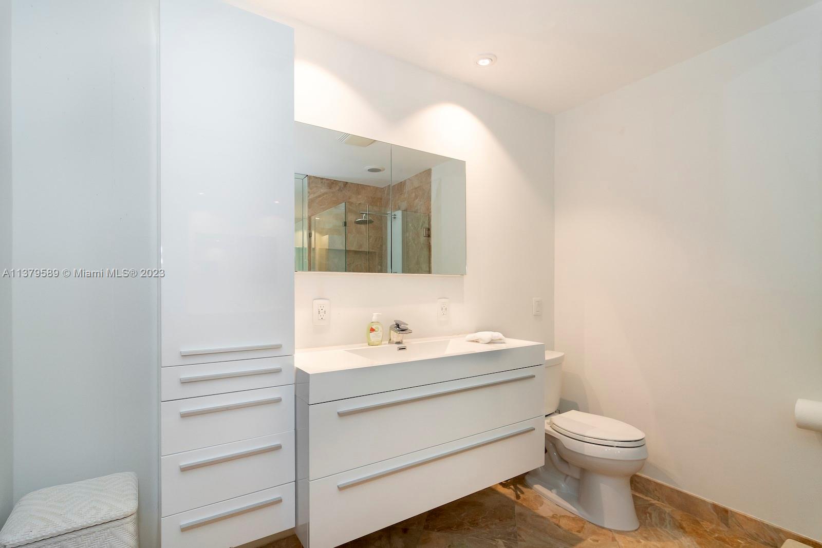 Doral Doral, FL 33178 - Photo 38 of 52 a bathroom with a toilet sink and mirror