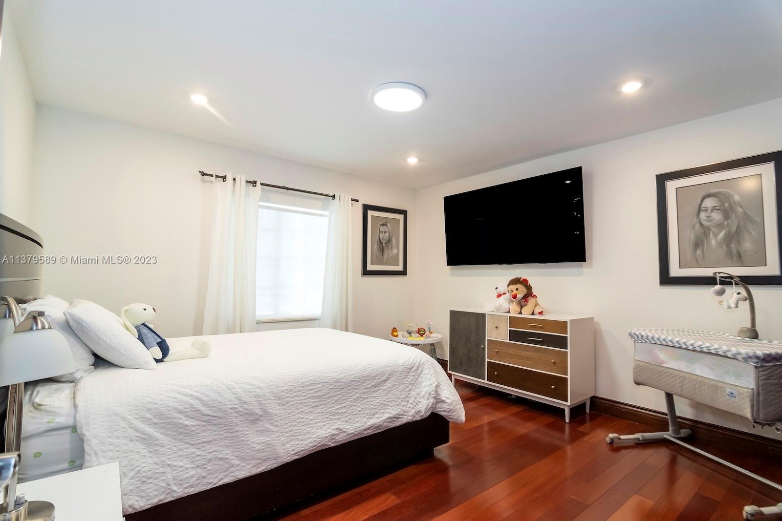 Doral Doral, FL 33178 - Photo 41 of 52 a bedroom with a bed and a flat screen tv