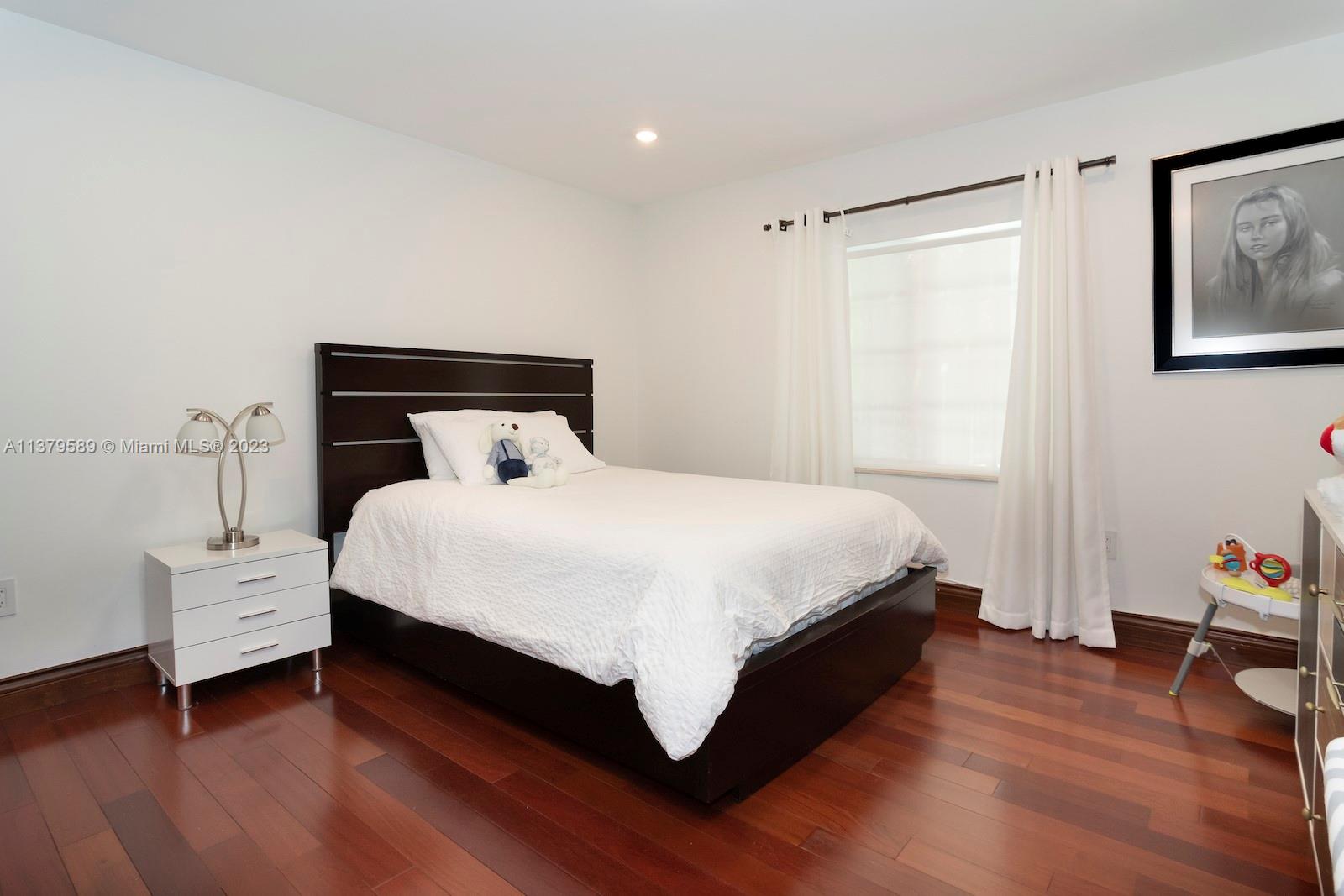 Doral Doral, FL 33178 - Photo 42 of 52 a bedroom with a bed and wooden floor