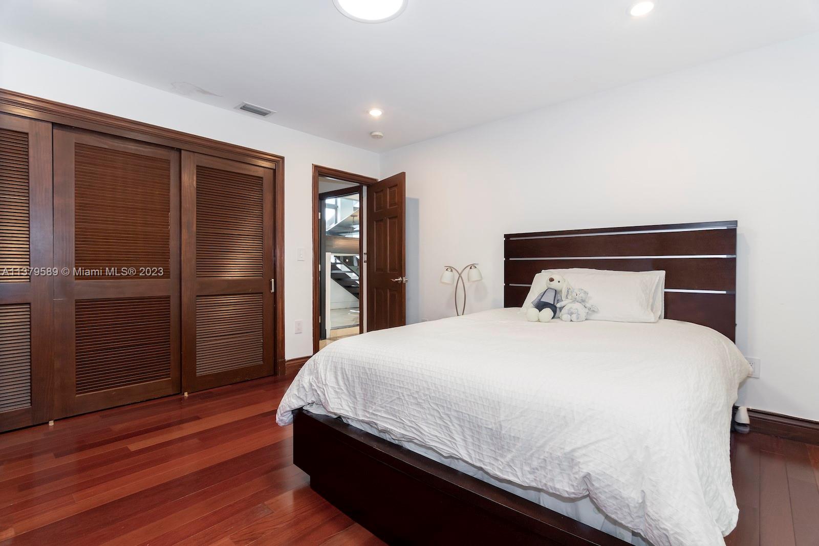 Doral Doral, FL 33178 - Photo 43 of 52 a bedroom with a bed and wooden floor