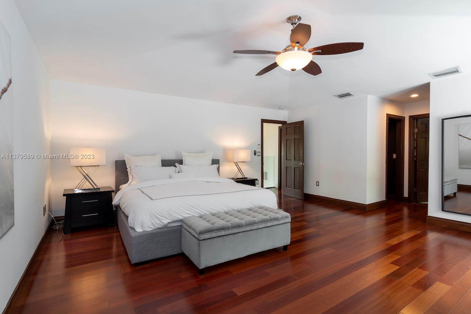 Doral Doral, FL 33178 - Photo 50 of 52 a bedroom with a bed and wooden floor