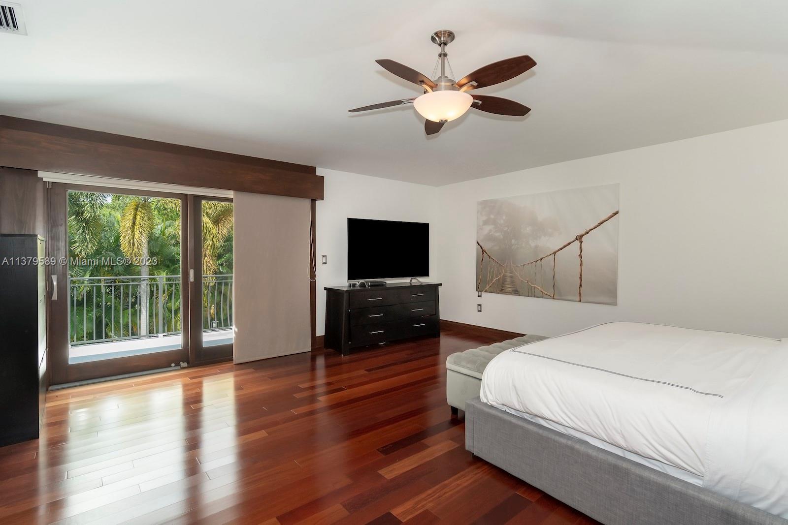 Doral Doral, FL 33178 - Photo 51 of 52 a bedroom with a large bed and a flat tv screen on dresser