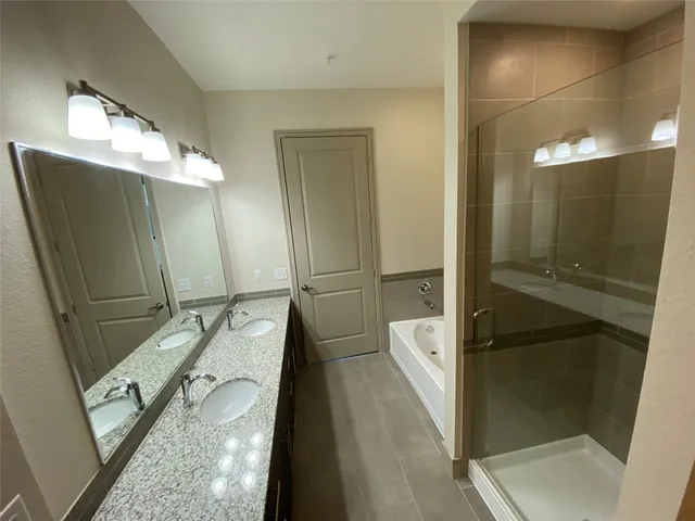 a bathroom with a double vanity sink and mirror