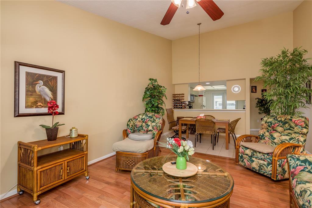 1381 McMullen Booth Road, Unit 1381 Clearwater, FL 33759 - Photo 13 of 36 a living room with furniture and a wooden floor