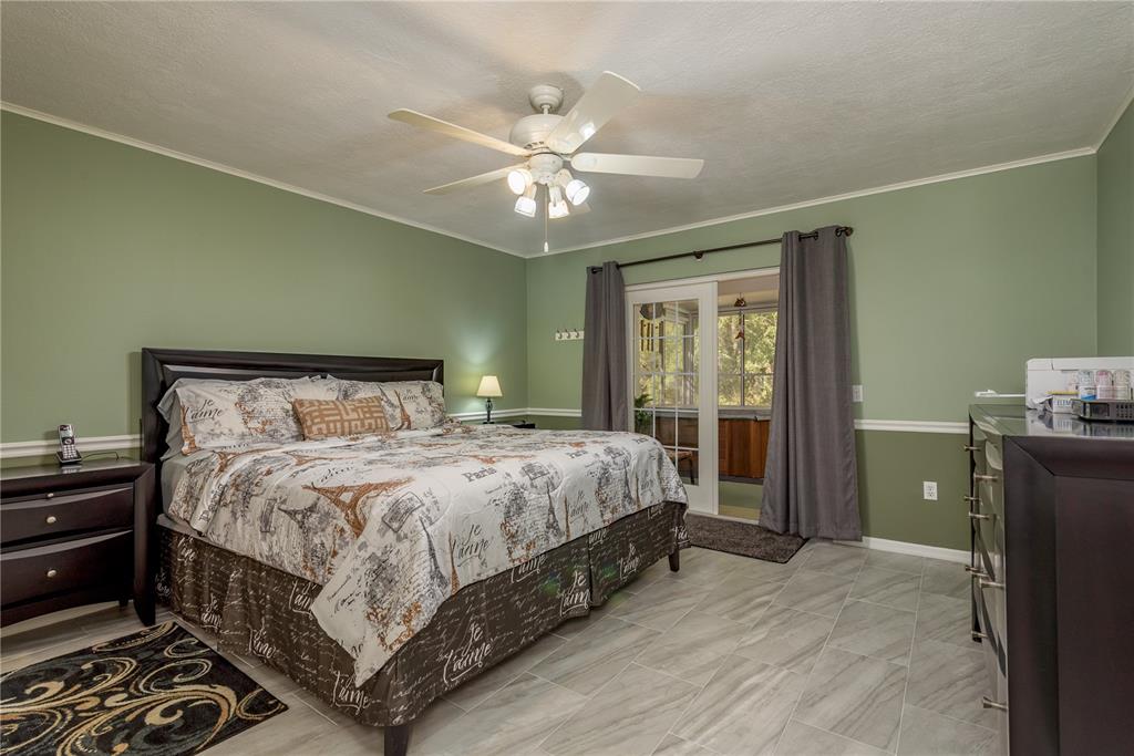 1381 McMullen Booth Road, Unit 1381 Clearwater, FL 33759 - Photo 15 of 36 a bedroom with a bed and a chandelier