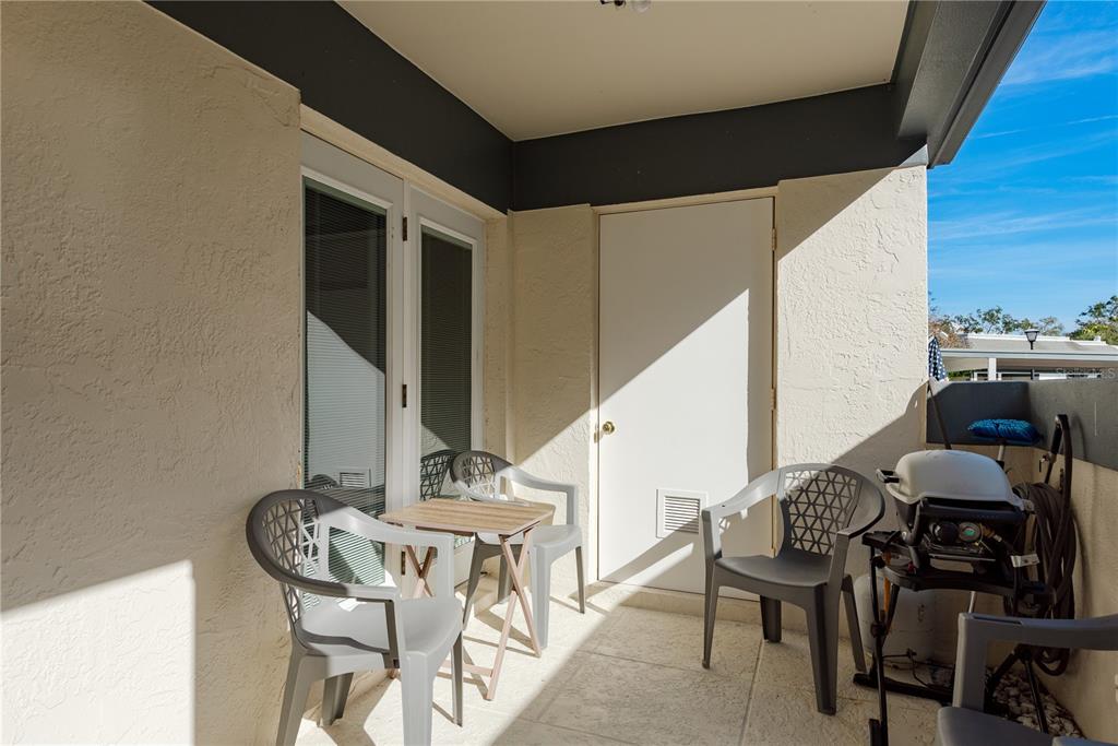 1381 McMullen Booth Road, Unit 1381 Clearwater, FL 33759 - Photo 3 of 36 a view of a dining room with furniture and wooden floor