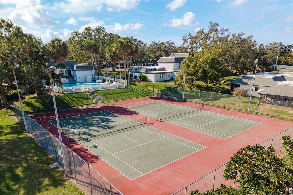 1381 McMullen Booth Road, Unit 1381 Clearwater, FL 33759 - Photo 34 of 36 a view of a tennis ground with large trees