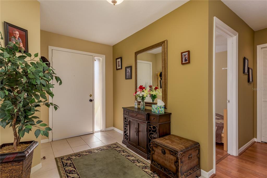 1381 McMullen Booth Road, Unit 1381 Clearwater, FL 33759 - Photo 4 of 36 a living room with furniture and flowers