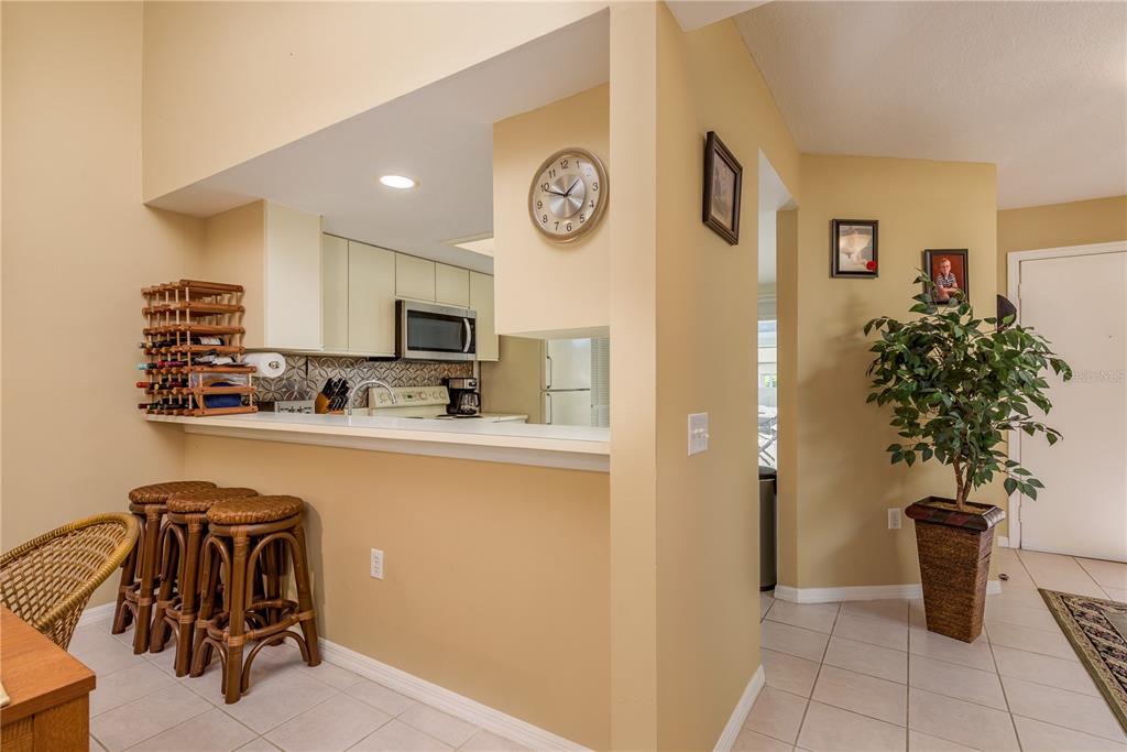 1381 McMullen Booth Road, Unit 1381 Clearwater, FL 33759 - Photo 5 of 36 a very nice looking open kitchen with stainless steel appliances granite countertop a refrigerator and a sink