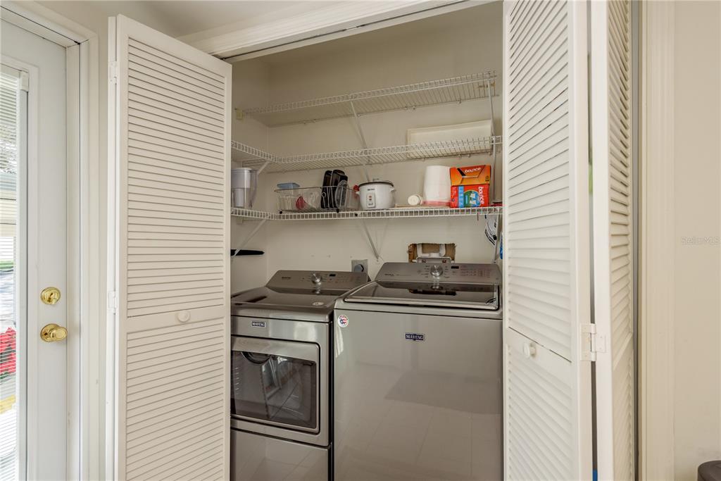 1381 McMullen Booth Road, Unit 1381 Clearwater, FL 33759 - Photo 10 of 36 a kitchen with stainless steel appliances granite countertop a sink and a stove