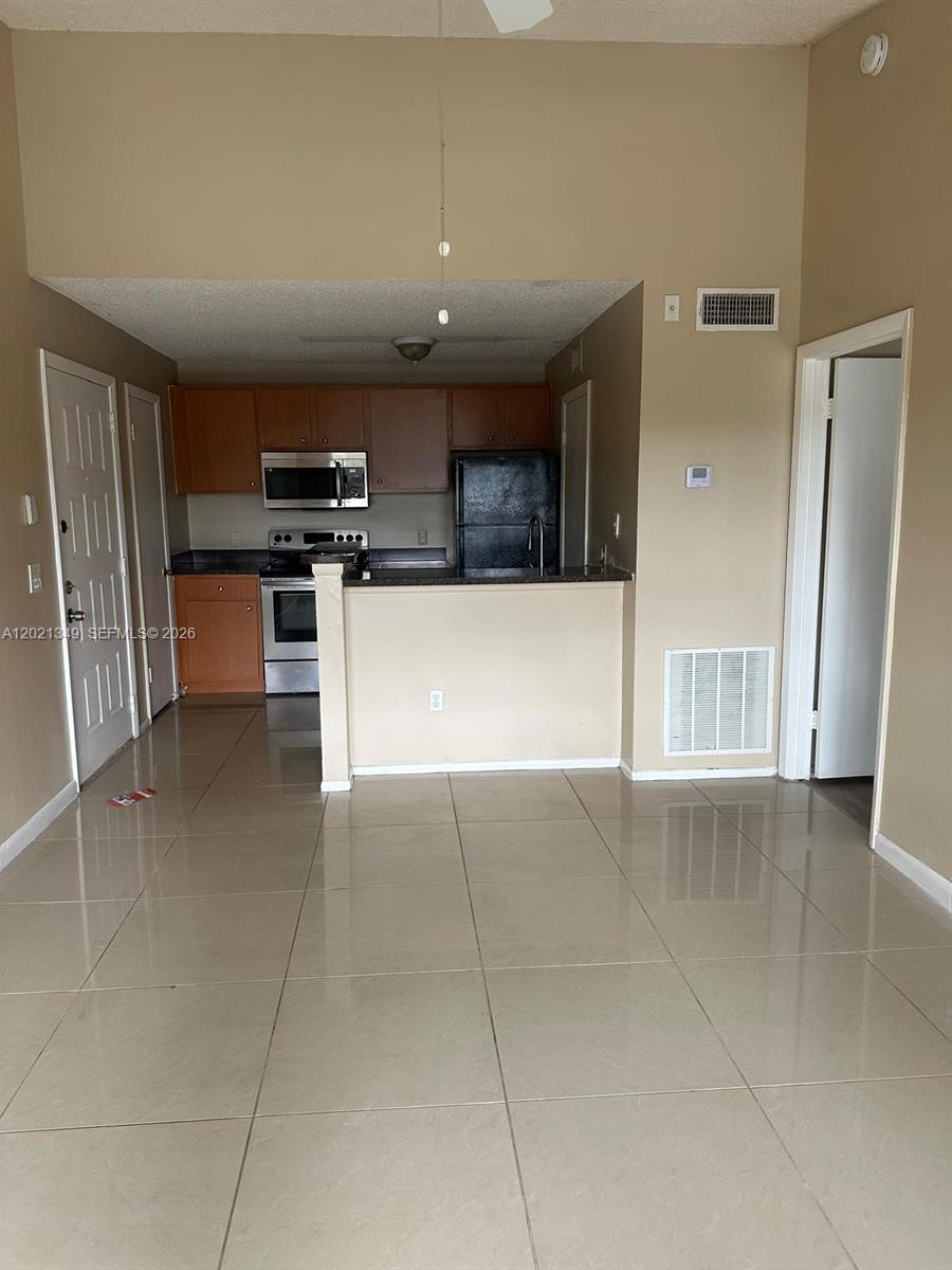 4481 West McNab Road, Unit 37 Pompano Beach, FL 33069 - Photo 15 of 20 a view of kitchen with stainless steel appliances a refrigerator and a stove top oven
