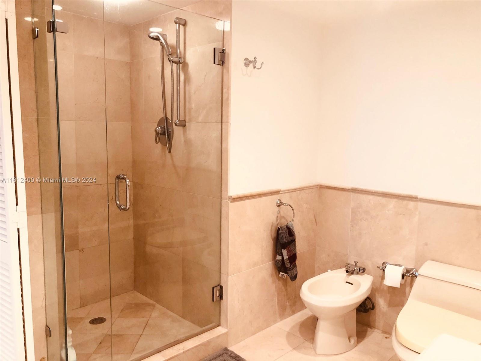 520 Brickell Key Drive, Unit A1005 Miami, FL 33131 - Photo 13 of 20 a bathroom with a toilet and shower