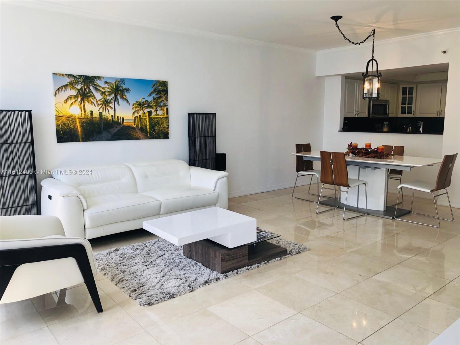 520 Brickell Key Drive, Unit A1005 Miami, FL 33131 - Photo 17 of 20 a living room with furniture and a flat screen tv