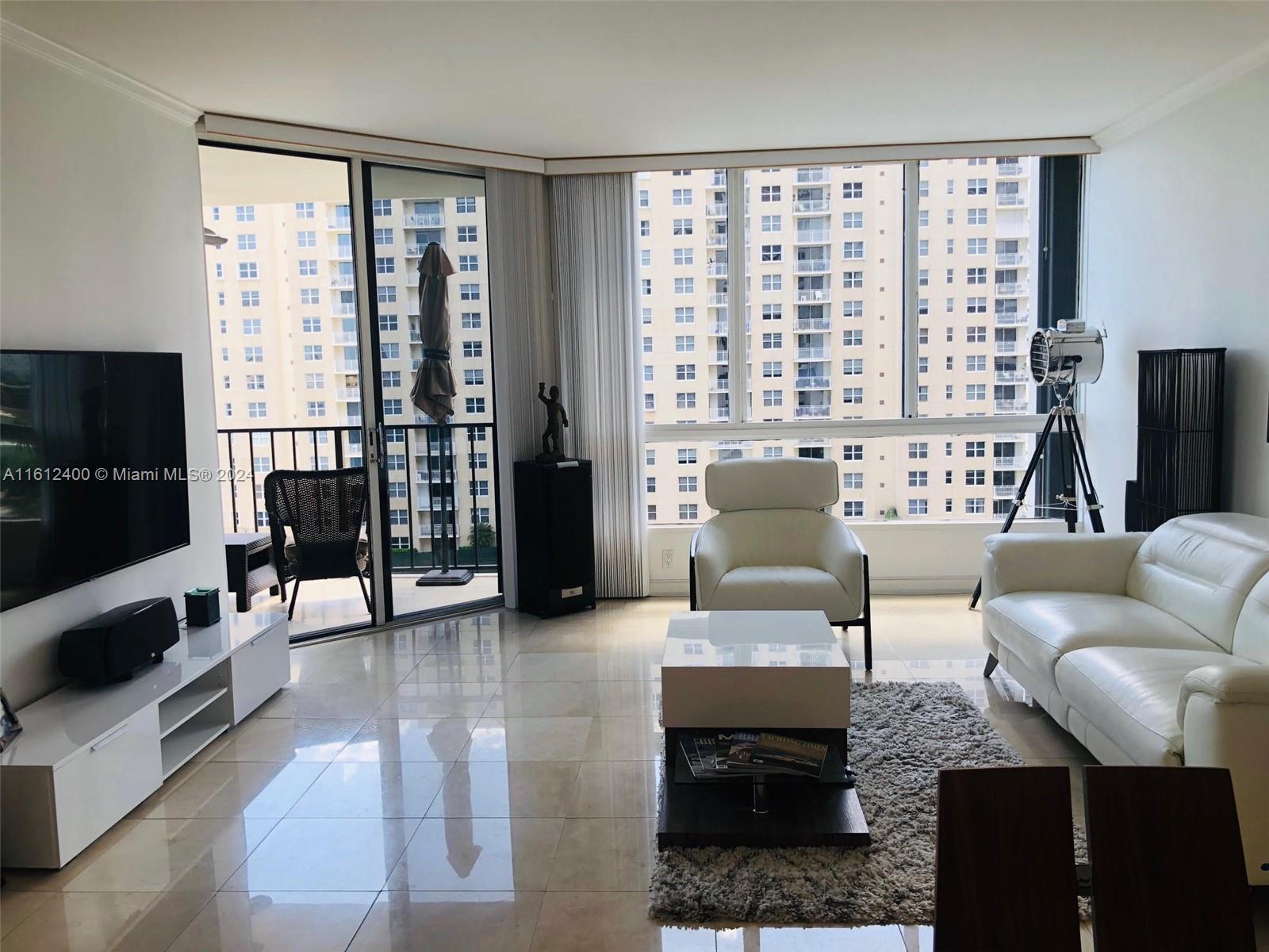 520 Brickell Key Drive, Unit A1005 Miami, FL 33131 - Photo 18 of 20 a living room with furniture and a flat screen tv