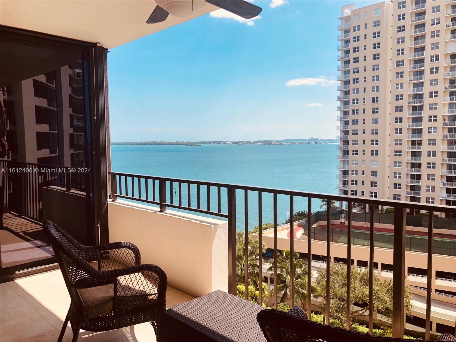 520 Brickell Key Drive, Unit A1005 Miami, FL 33131 - Photo 20 of 20 a view of a balcony with chair and wooden floor