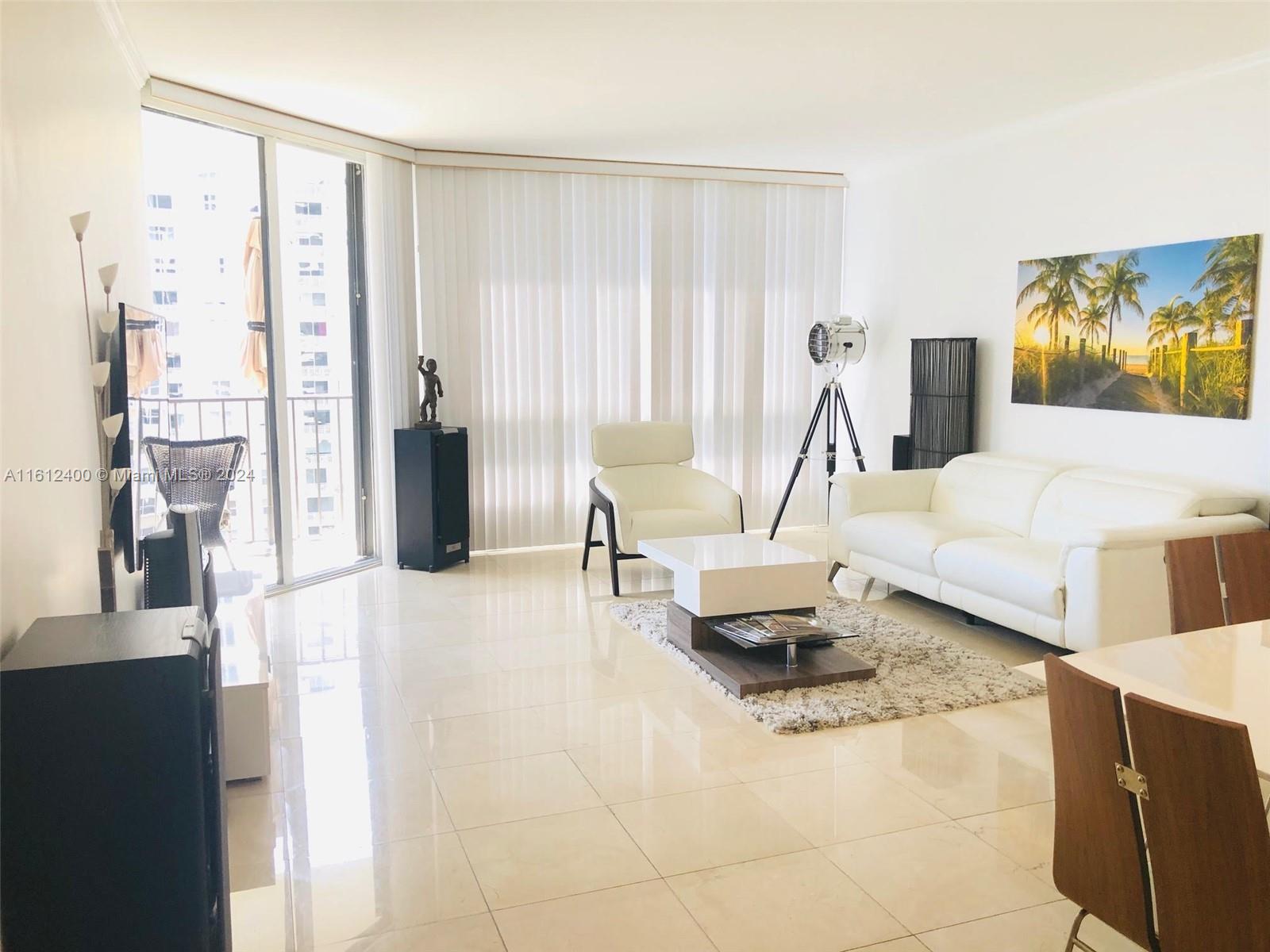 520 Brickell Key Drive, Unit A1005 Miami, FL 33131 - Photo 4 of 20 a living room with furniture and a large window
