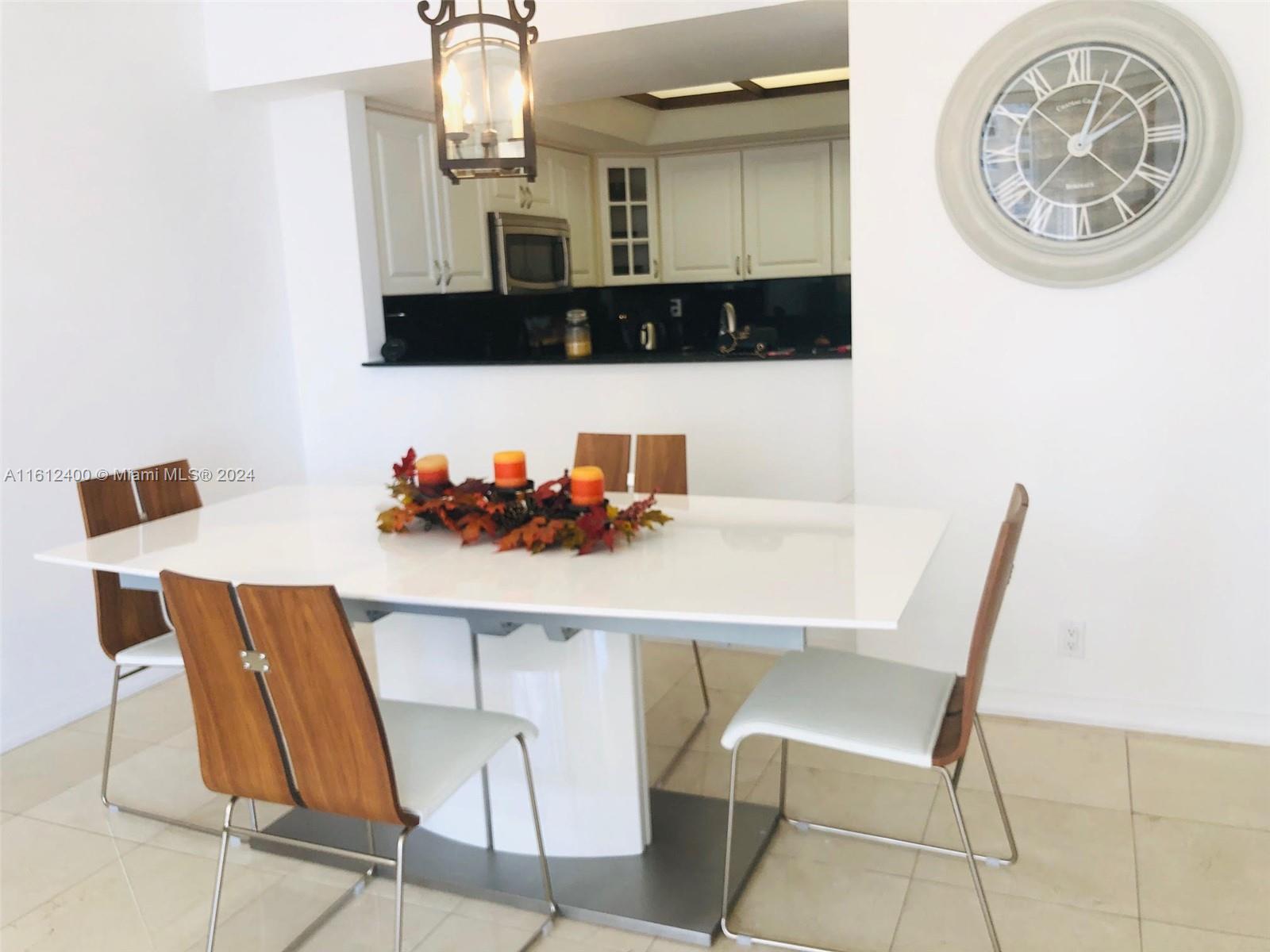 520 Brickell Key Drive, Unit A1005 Miami, FL 33131 - Photo 6 of 20 a dining room with table chairs and a view of kitchen