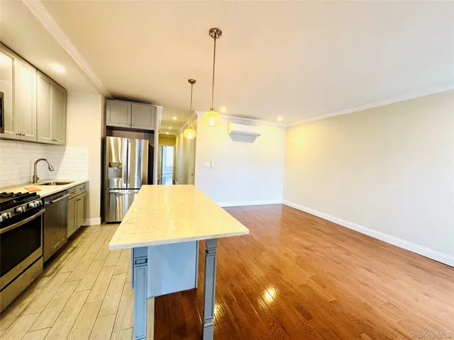 a kitchen with stainless steel appliances granite countertop a sink stove and refrigerator