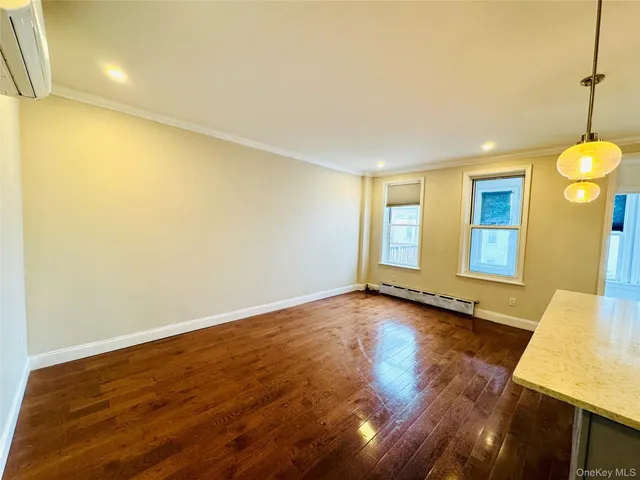 a view of a room with wooden floor