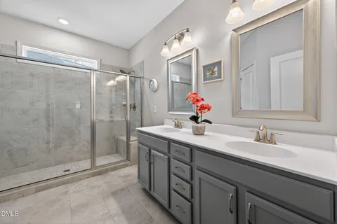 a bathroom with a shower sink and mirror