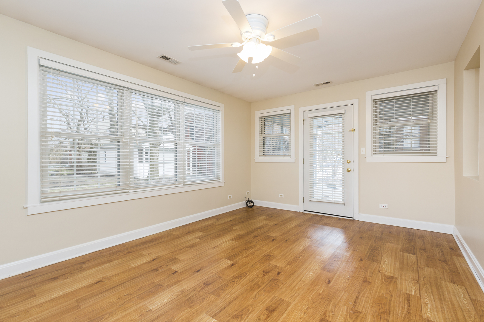 27 North Delaplaine Road Riverside, IL 60546 - Photo 11 of 32 a view of an empty room with a window and wooden floor