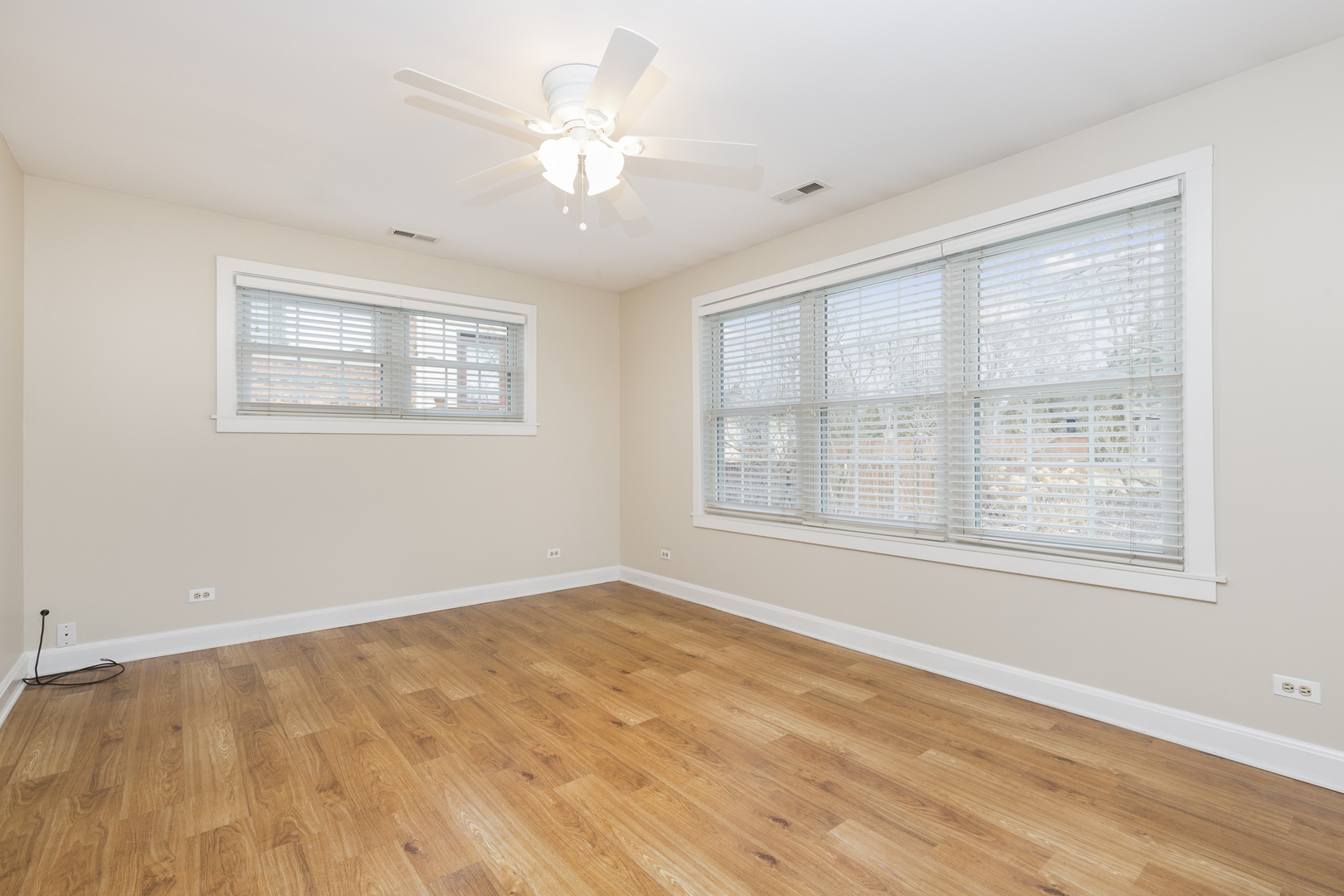 27 North Delaplaine Road Riverside, IL 60546 - Photo 12 of 32 a view of an empty room with a window and wooden floor