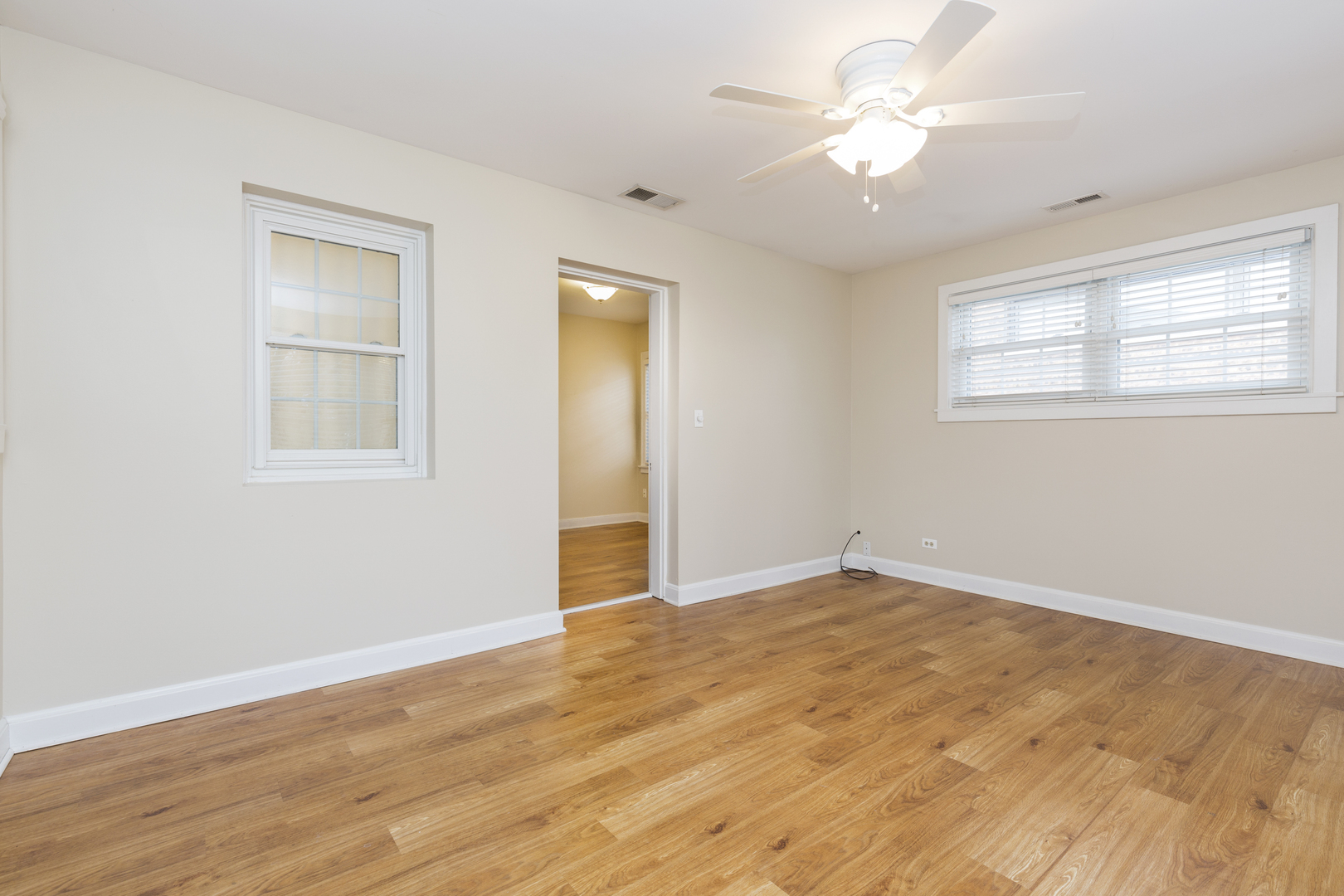 27 North Delaplaine Road Riverside, IL 60546 - Photo 13 of 32 a view of an empty room with window and wooden floor