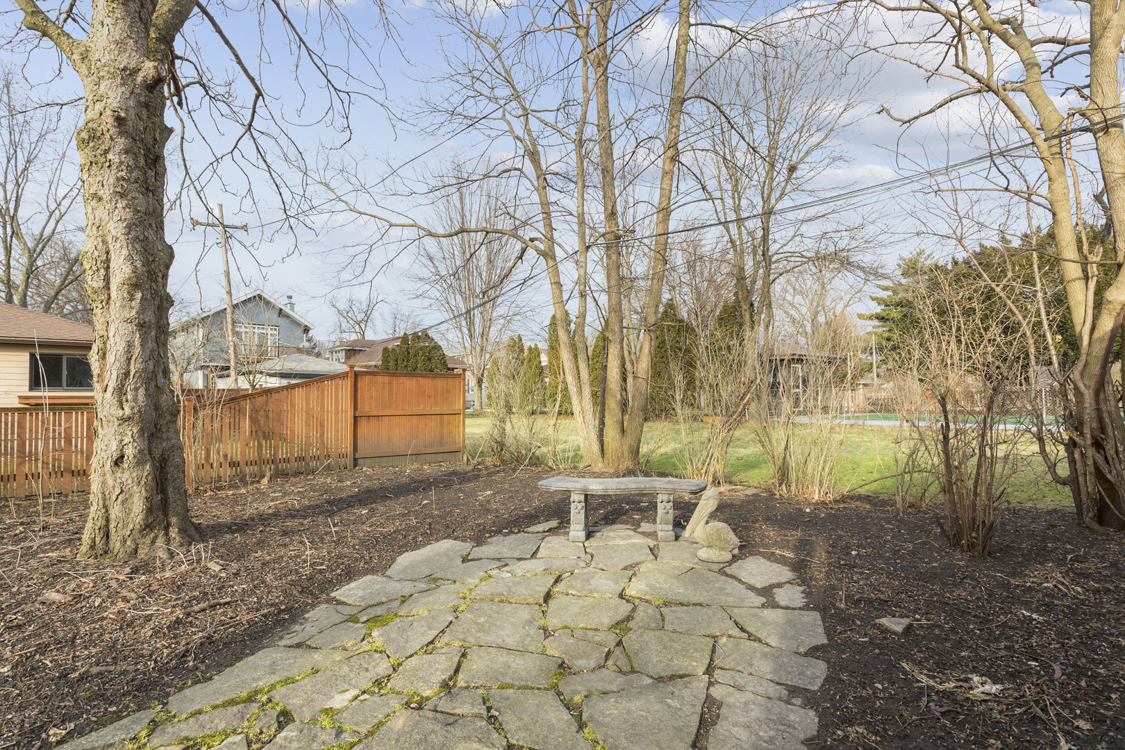 27 North Delaplaine Road Riverside, IL 60546 - Photo 22 of 32 a backyard of a house with table and chairs