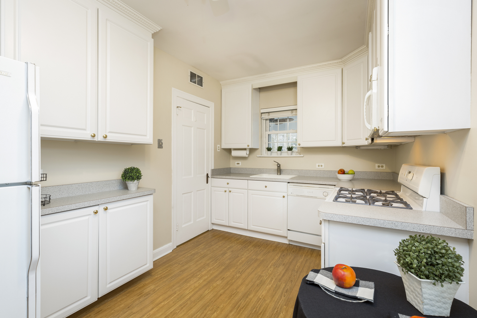 27 North Delaplaine Road Riverside, IL 60546 - Photo 5 of 32 a kitchen with stainless steel appliances granite countertop a sink dishwasher stove and white cabinets with wooden floor