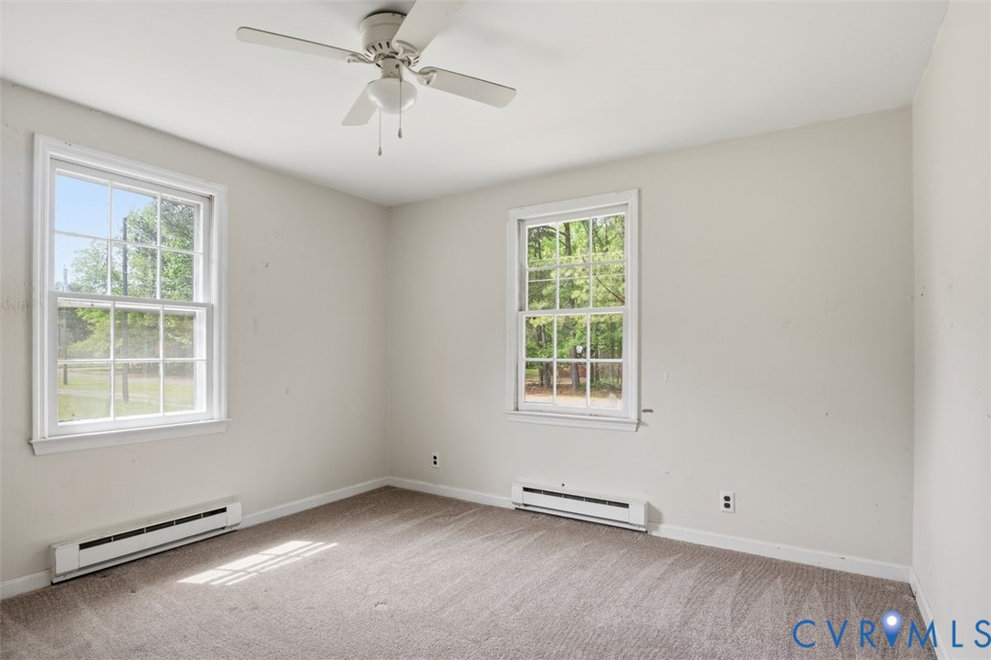 14527 Arwood Road Disputanta, VA 23842 - Photo 15 of 20 an empty room with a window and a ceiling fan