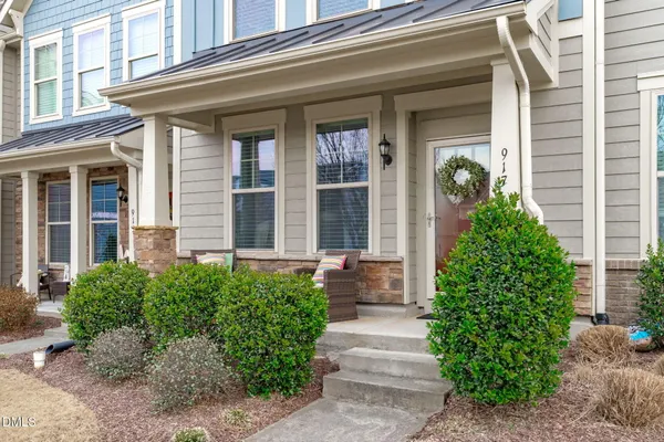 a view of a house with potted plants