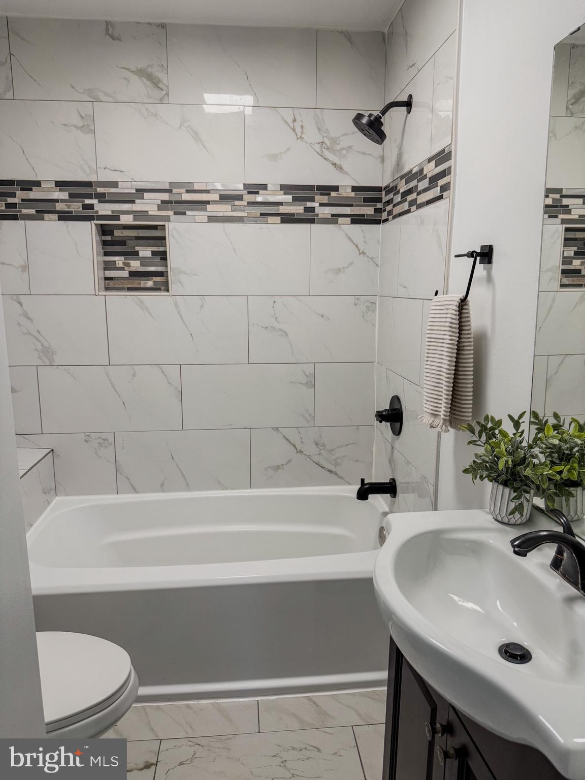 1803 Amherst Road Hyattsville, MD 20783 - Photo 15 of 17 a bathroom with a sink and a mirror