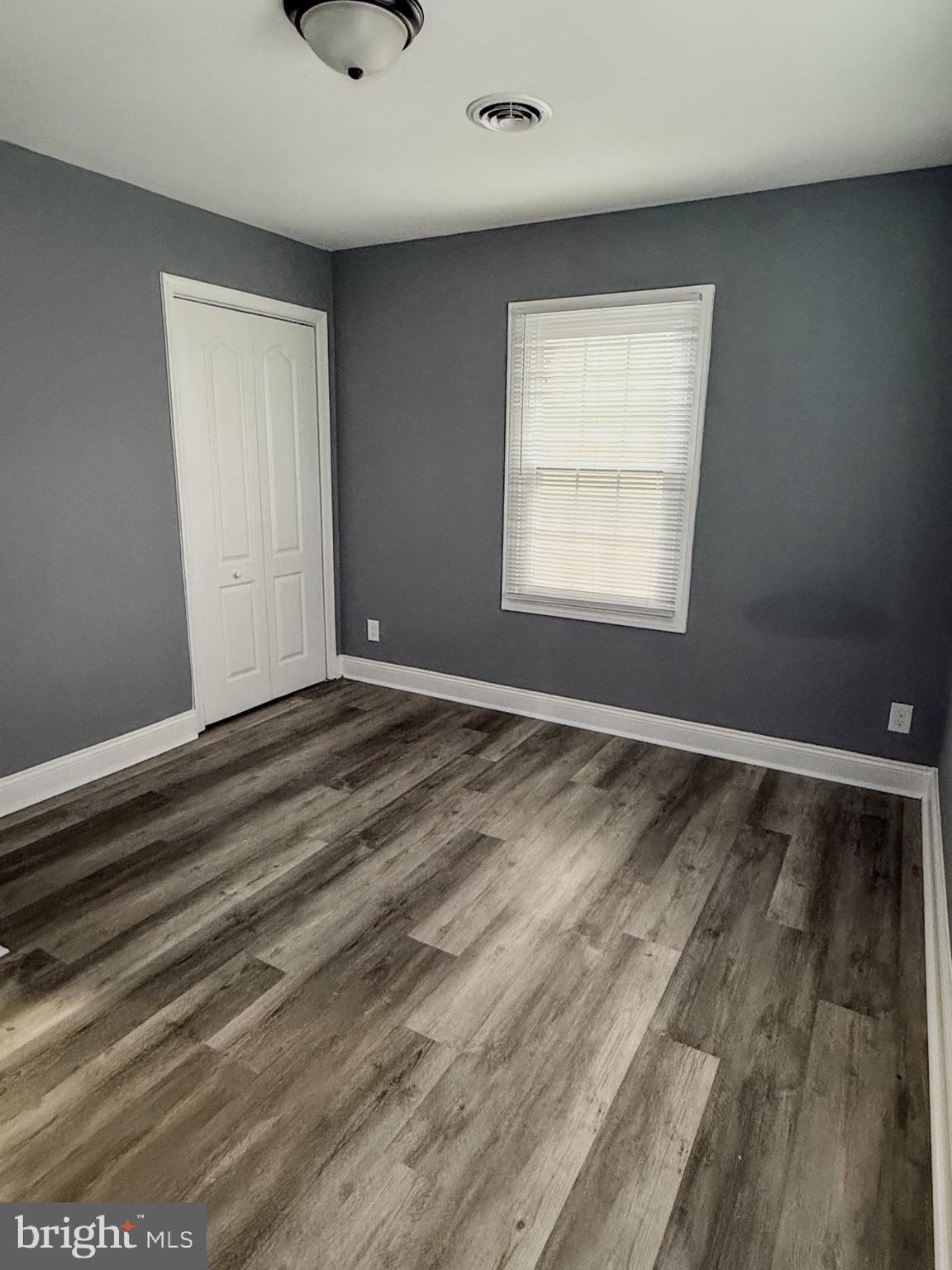 1803 Amherst Road Hyattsville, MD 20783 - Photo 17 of 17 a view of an empty room with wooden floor and a window
