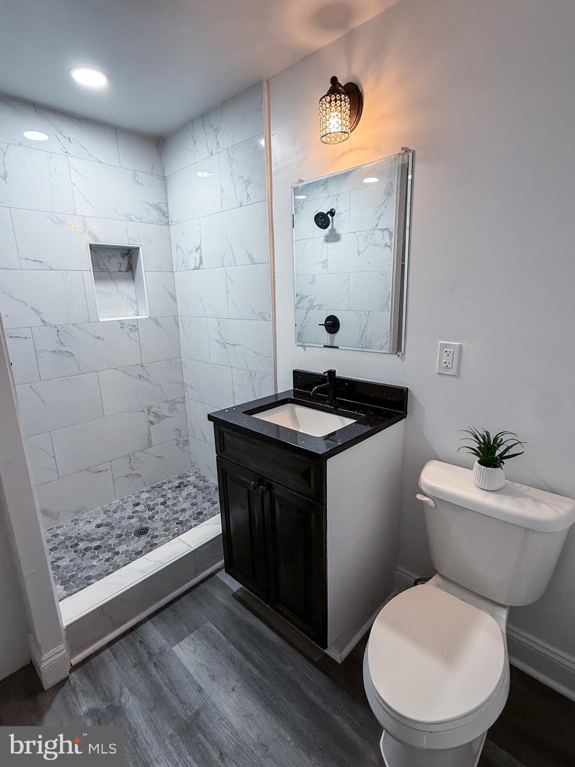 1803 Amherst Road Hyattsville, MD 20783 - Photo 5 of 17 a bathroom with a toilet a sink and mirror