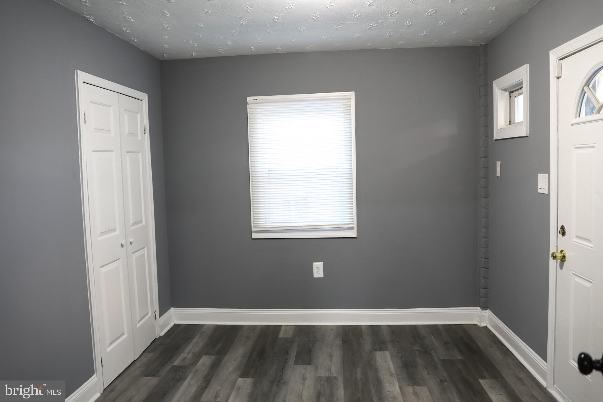 1803 Amherst Road Hyattsville, MD 20783 - Photo 7 of 17 a view of an empty room with wooden floor and a window