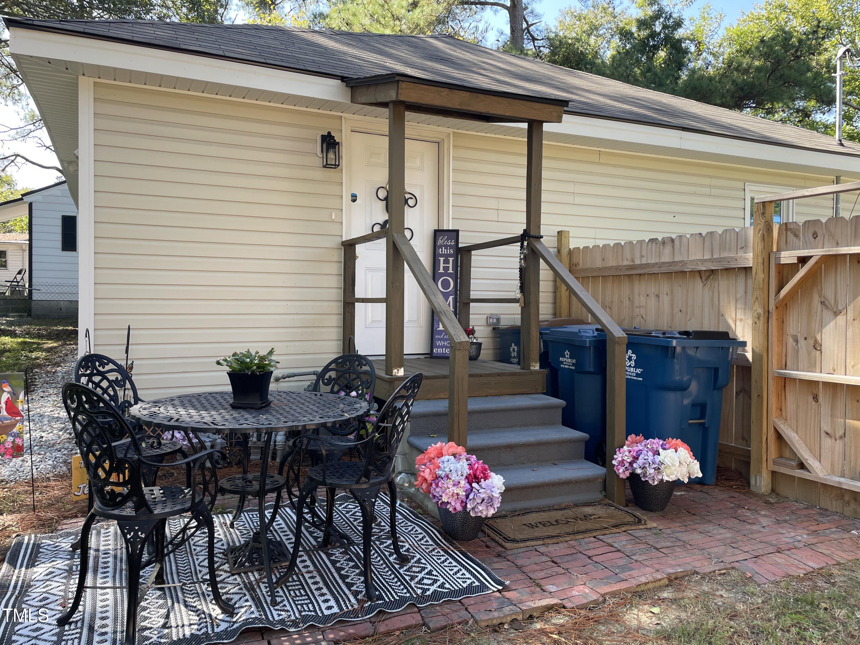 204 Jackson Street Dunn, NC 28334 - Photo 13 of 49 a view of backyard with seating space and potted plants