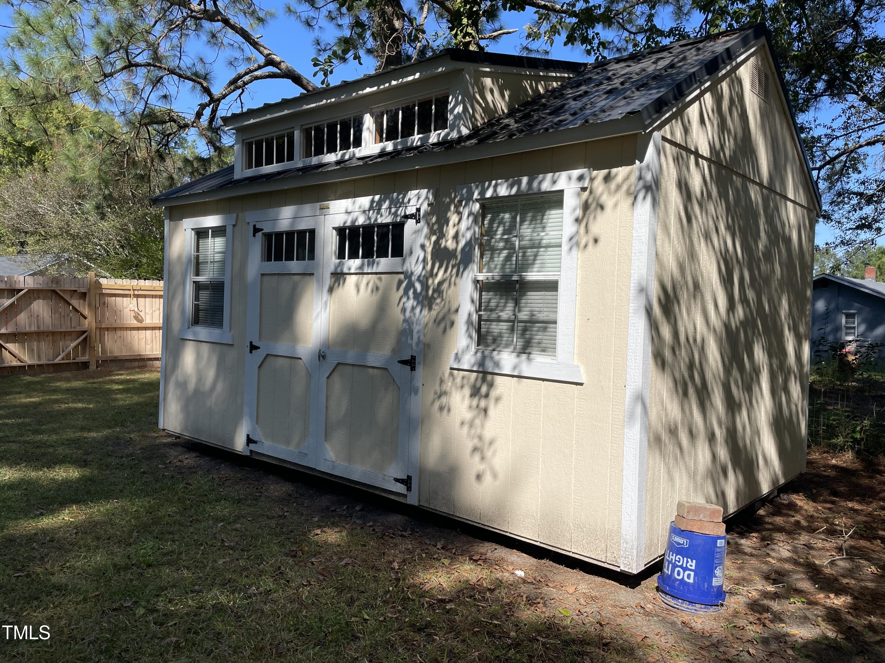 204 Jackson Street Dunn, NC 28334 - Photo 16 of 49 a view of a house with a yard
