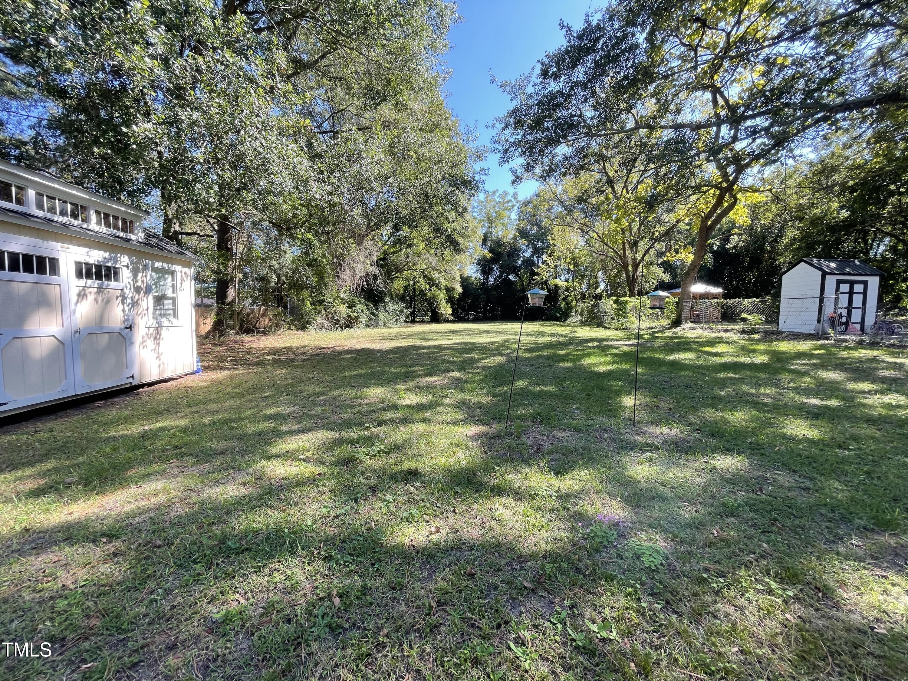 204 Jackson Street Dunn, NC 28334 - Photo 19 of 49 a backyard of a house with table and chairs