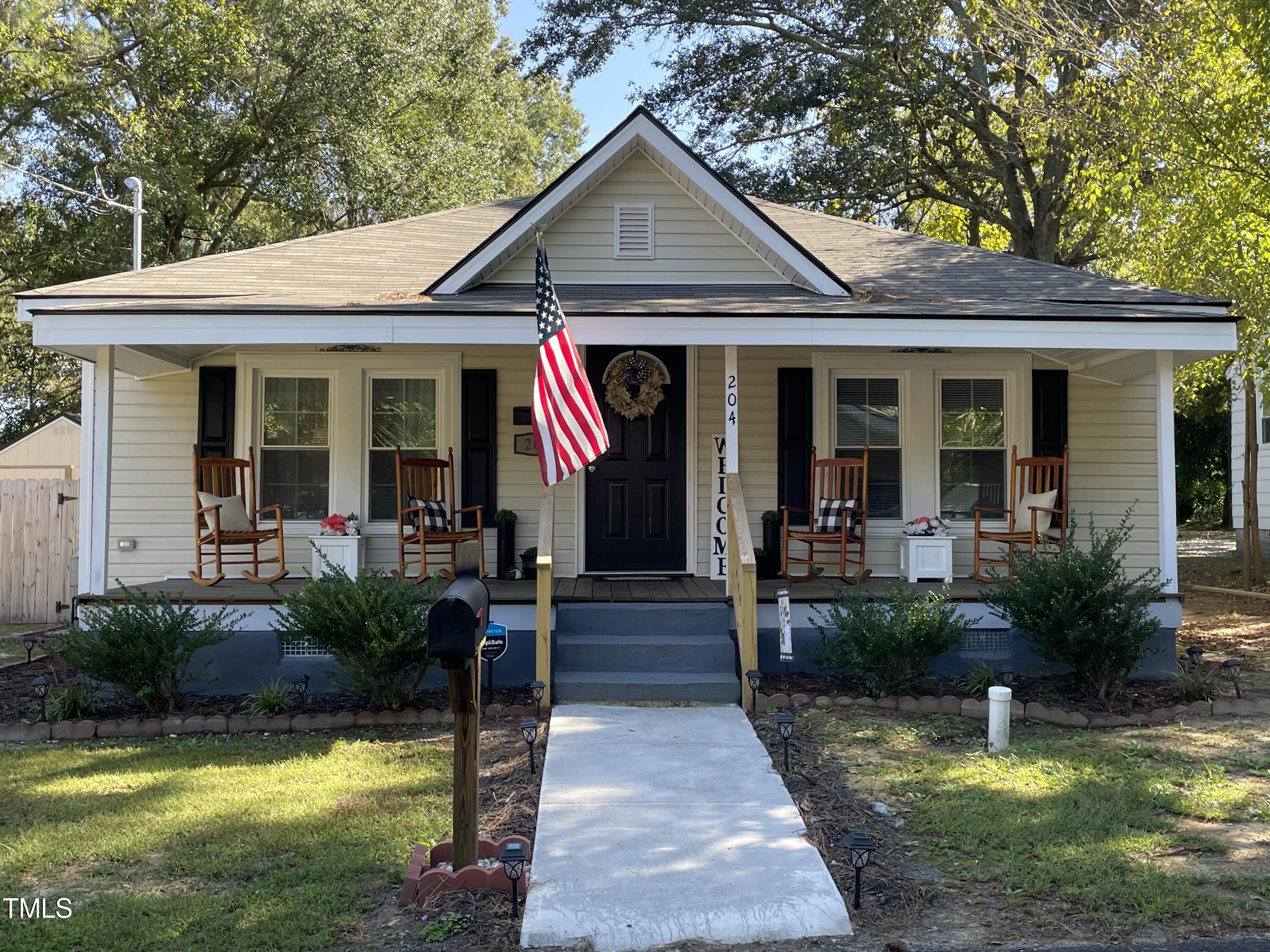 204 Jackson Street Dunn, NC 28334 - Photo 2 of 49 a front view of a house with garden