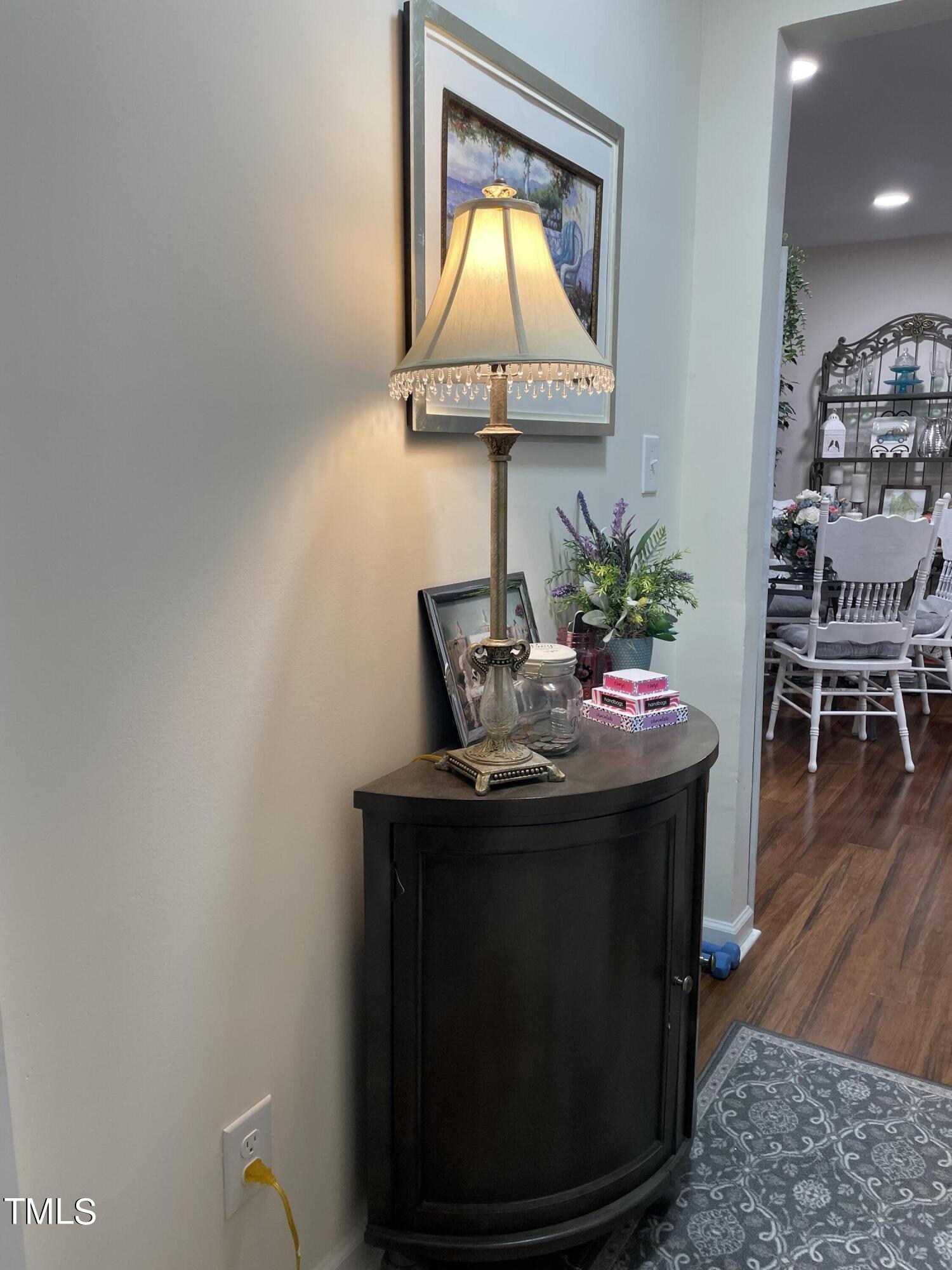 204 Jackson Street Dunn, NC 28334 - Photo 24 of 49 a room with a table chairs and a potted plant