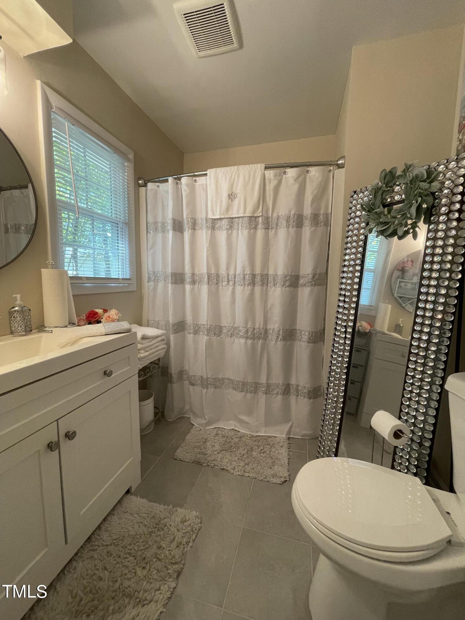 204 Jackson Street Dunn, NC 28334 - Photo 25 of 49 a bathroom with a toilet sink and shower