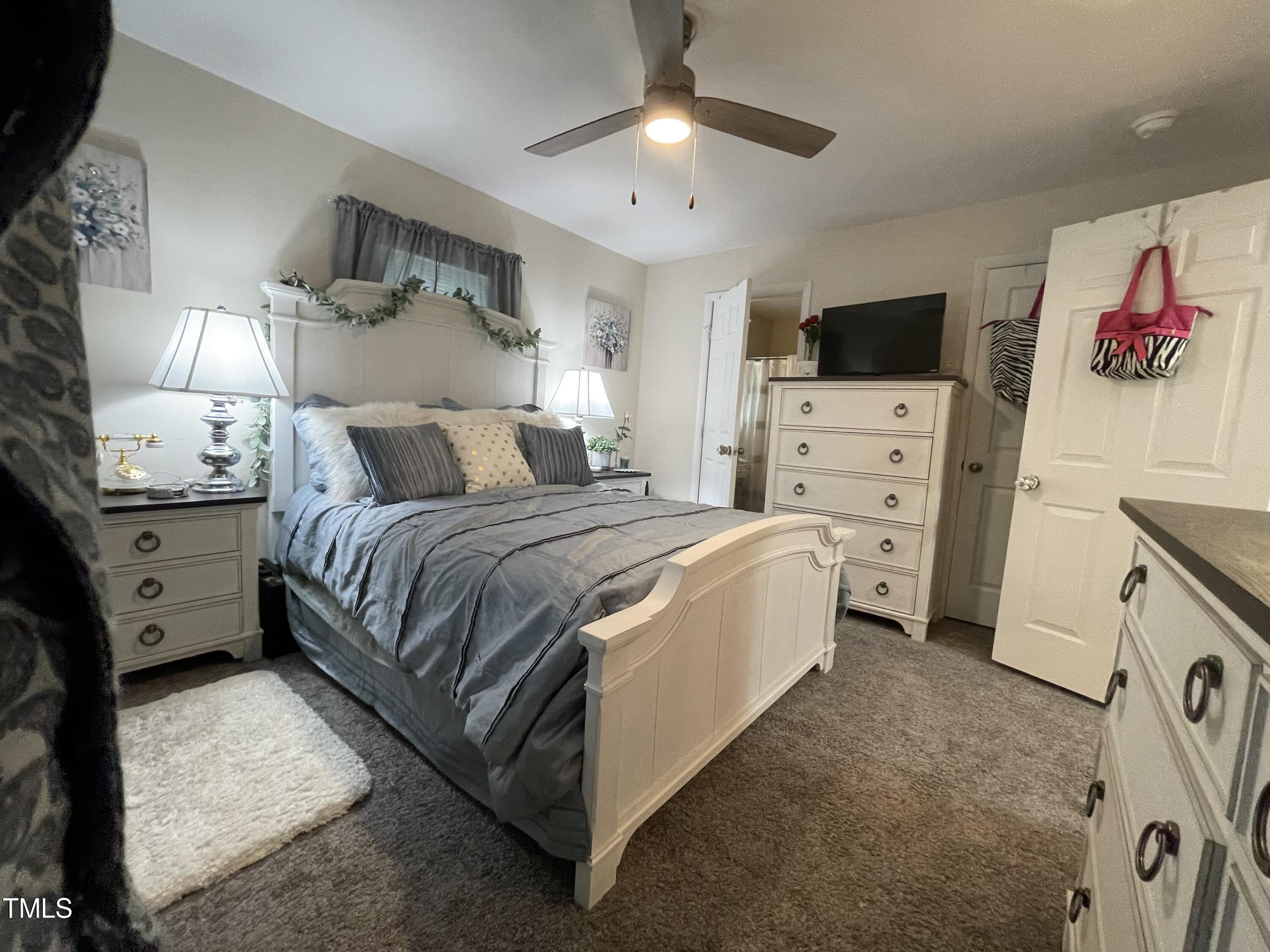 204 Jackson Street Dunn, NC 28334 - Photo 28 of 49 a bedroom with a bed and a flat screen tv